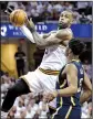  ?? AP/TONY DEJAK ?? Cleveland forward LeBron James (left) looks to pass around Indiana defender Myles Turner as the Cavaliers’ held on late to beat the Pacers 117-111 in Game 2 of their NBA Eastern Conference playoff series Monday.