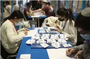  ?? MAYA ALLERUZZO AP ?? Workers count votes in Israel’s national elections while divided in groups to help curb the spread of the coronaviru­s at the Knesset in Jerusalem on Thursday.