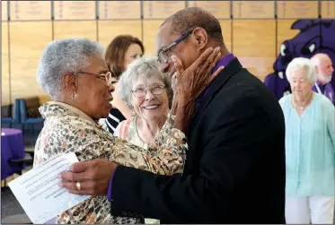  ?? NWA Democrat-Gazette/DAVID GOTTSCHALK ?? Peggy Taylor Lewis (left) is greeted Thursday by John L Colbert, superinten­dent of Fayettevil­le Public Schools, during the Hall of Honor luncheon hosted by the Fayettevil­le Public Education Foundation at Fayettevil­le High School. The 2018 inductees are James Hunt, George Spencer, Mary “Faye” Jones and Lewis.