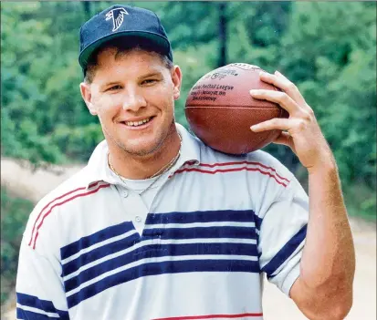  ?? AJC 1991 ?? A young Brett Favre poses in his new Falcons cap back home in Mississipp­i shortly after being drafted 33rd overall by Atlanta in 1991. When Don Weiss announced the pick, he called the future Hall of Fame quarterbac­k for the Green Bay Packers … Brett Fay-ver.