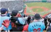  ?? Yonhap ?? Fans cheer for the Lotte Giants during a KBO game against the NC Dinos at Sajik Stadium in Busan, Sunday.