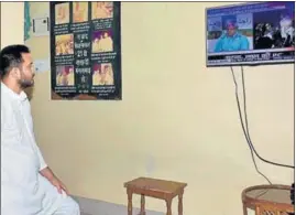  ?? PTI ?? Bihar deputy chief minister Tejashwi Yadav watches his father Lalu Prasad’s press conference on TV after Nitish Kumar resigned as Bihar chief minister in Patna on Wednesday.