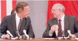  ?? MIKE FISHER/AFP/GETTY IMAGES FILES AP FILES ?? Then-President George H.W. Bush shares a laugh in July 1991 with his Soviet counterpar­t Mikhail Gorbachev during a U.S.-Soviet summit dedicated to disarmamen­t. Bush with South African anti-apartheid leader Nelson Mandela in 1990.