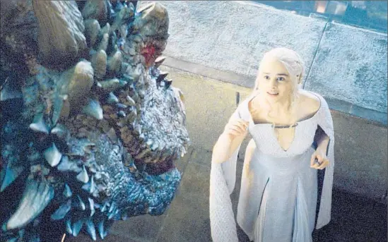  ?? HBO ?? DAENERYS TARGARYEN
(Emilia Clarke) greets one of her three dragons — no longer mere youngsters — in the new season of HBO’s “Game of Thrones.”