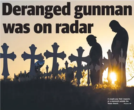  ?? Picture: AP ?? A couple pay their respects at a memorial outside the Texas church.