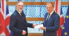  ?? AP ?? Britain's permanent representa­tive to the European Union Tim Barrow (left) delivers British Prime Minister Theresa May's Brexit letter to EU Council President Donald Tusk, in Brussels, Belgium, on Wednesday. The letter formally triggers the beginning...