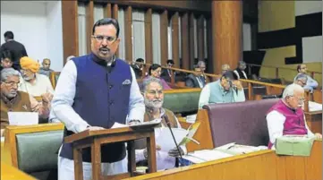  ?? HT PHOTO ?? Haryana finance minister Capt Abhimanyu presenting the state budget for 201819 in the state assembly in Chandigarh on Friday. Chief minister Manohar Lal Khattar is also seen in the picture (right).