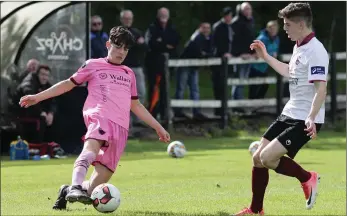  ??  ?? Oscar Smith of Wexford F.C. Under-17s tries to evade the challenge of Galway’s Liam Og Horkan.