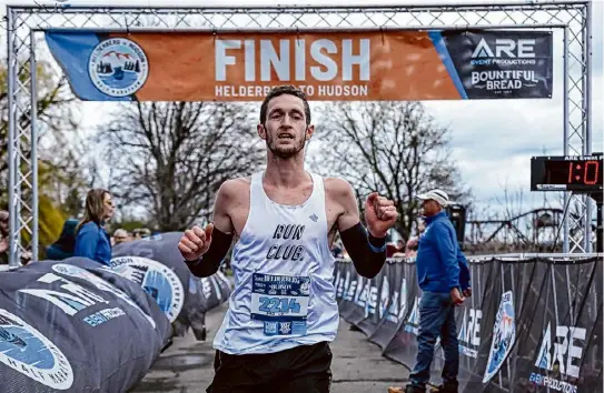  ?? Photos by Jim Franco/Times Union ?? Ryan Udvadia, of Clifton Park, wins the Helderberg to Hudson Half Marathon on Saturday in Albany in a personal record.