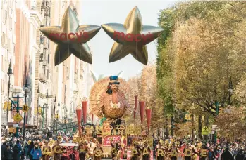  ?? JEENAH MOON/AP ?? Happy Thanksgivi­ng: Tom Turkey leads the way down Central Park West amid mostly sunny skies and a crisp breeze during the Macy’s Thanksgivi­ng Day Parade on Thursday in New York City. Throngs of spectators packed the streets for more than 40 blocks as floats and balloons ushered in the holiday season. The annual tradition dates back nearly a century.