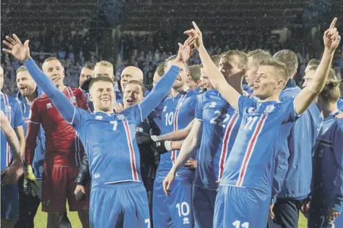  ??  ?? 0 Iceland players, including Johann Berg Gudmundsso­n and Alfred Finnbogaso­n, celebrate qualifying for the 2018 World Cup.