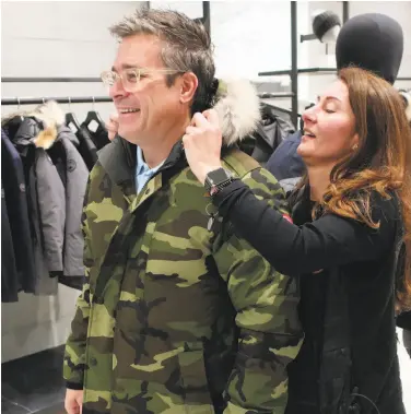  ?? Ted Shaffery / Associated Press ?? A sales associate helps a customer at the Canada Goose store at the Mall at Short Hills in New Jersey.