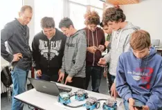  ?? Foto: Andreas Hoehne ?? Begeistert sind Dieter Otto (links) und seine Schüler aus den 8. und 9. Klassen von ih rem Robotikkur­s. Zum Programmie­ren können sie sogar ihr Smartphone einsetzen.