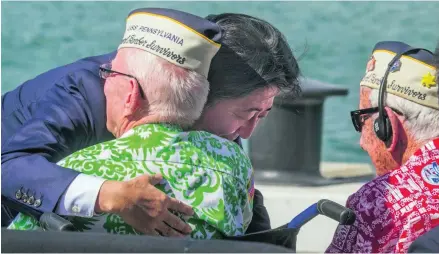  ?? AP Photo ?? Japanese prime minister Shinzo Abe embraces a Pearl Harbour survivor at the USS Arizona Memorial in Hawaii.