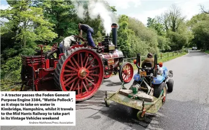  ?? Andrew Matthews/Press Associatio­n ?? > A tractor passes the Foden General Purpose Engine 3384, “Wattie Pollock”, as it stops to take on water in Kimbridge, Hampshire, whilst it travels to the Mid Hants Railway to take part in its Vintage Vehicles weekend