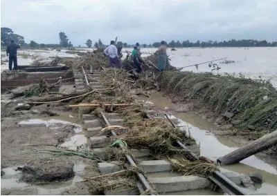  ?? — Reuters ?? Railway tracks are seen under water after the spillway of an irrigation dam burst at Swar creek in Swar township, Myanmar.