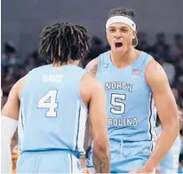  ?? TONY GUTIERREZ/AP ?? RJ Davis and Armando Bacot celebrate during No. 8 seed North Carolina’s win over No. 1 seed Baylor in an East Region second-round game Saturday. Baylor was the defending national champion.