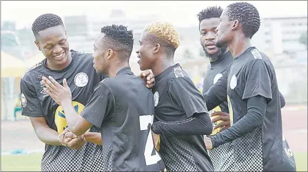  ?? (Pic: Ntokozo Magongo) ?? Mbabane Highlander­s players celebrate their 3-1 win over Manzini Wanderers on Sunday during the MoMo Cup play-offs at Mavuso Sports Centre.