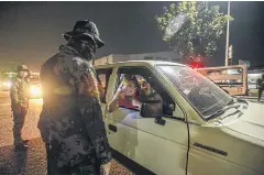  ?? AFP ?? Forces randomly inspect vehicles at a check point in Manila during the implementa­tion of measures to limit the spread of Covid-19.