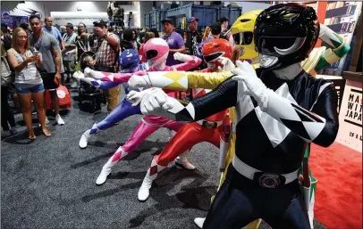  ?? The Associated Press ?? MIGHTY MORPHIN: Power Ranger characters strike a pose for Comic-Con attendees during Preview Night of the 2017 Comic-Con Internatio­nal on Wednesday in San Diego, Calif.