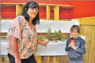  ??  ?? Margaret MacNeil with grandson Quinn and his winning miniature garden.