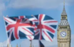  ?? FRANK AUGSTEIN/AP ?? Union Jack flags are seen in front of the Elizabeth Tower, known as Big Ben, beside the Houses of Parliament last month in London. After restoratio­n, Big Ben is back.