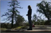  ?? ERIC RISBERG — THE ASSOCIATED PRESS ?? Jason Meek, whose Northern California wine country home was destroyed in 2017, stands in the driveway and looks out at the remains of his home in Santa Rosa on Tuesday.