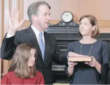  ??  ?? Judge Brett Kavanaugh is sworn in at the U.S. Supreme Court Building in Washington, D.C., on Saturday. Kavanaugh’s wife, Ashley, holds the Bible. In the foreground is their daughter, Liza.