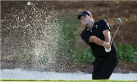  ?? Photograph: Sam Greenwood/Getty Images ?? Patrick Reed splashes out of a bunker during a practice round at Sawgrass.