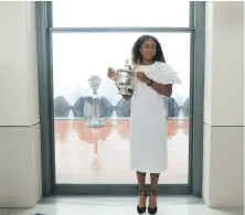  ??  ?? Women’s champion Naomi Osaka with the US Open trophy at the top of the Rock Observator­y in New York