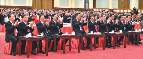  ?? JU PENG AND LI TAO / XINHUA ?? Top: President Xi Jinping, also general secretary of the Communist Party of China Central Committee and chairman of the Central Military Commission, gives a speech at the 2018 Spring Festival reception of the CPC Central Committee and the State Council...