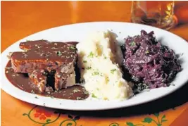  ?? AMY BETH BENNETT/SUN SENTINEL ?? The Hackbraten, or meatloaf, is a standard dish at the German-American Cypress Nook Restaurant in Pompano Beach.