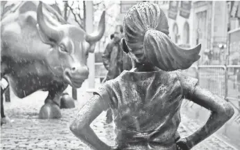  ?? BEBETO MATTHEWS, AP ?? Fearless Girl faces off with Charging Bull in Lower Manhattan’s Financial District in March.