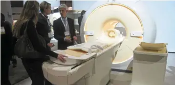  ?? ― AFP ?? Increased screening: Visitors checking out an MRI at a health conference in the US. Global health-care spending is expected to rise 5.8% to US$8.8 trillion this year.