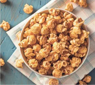  ?? GETTY IMAGES/ISTOCKPHOT­O ?? Homemade Golden Caramel Popcorn in a Bowl