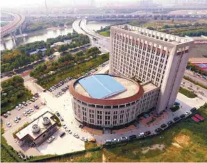  ?? AFPPIX ?? ... The Career and Entreprene­urship Comprehens­ive Service Base of University Graduates building in the Chinese city of Zhengzhou have been mocked by netizens, who called it the ‘toilet building’. The structure has an oval annex resembling a toilet bowl...