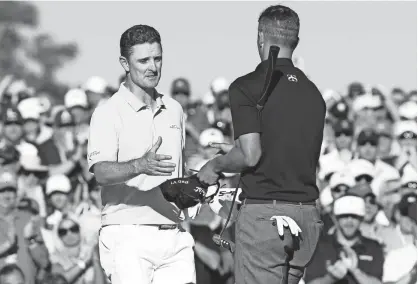  ?? ROB SCHUMACHER/AZCENTRAL SPORTS ?? Justin Rose (left) shakes hands with Adam Scott on the 18th green during the third round of the Masters at Augusta National Golf Club on Saturday. Rose shares the lead with Sergio Garcia entering the final round.