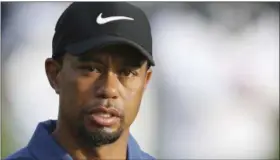  ?? KAMRAN JEBREILI — THE ASSOCIATED PRESS FILE ?? In this file photo, Tiger Woods reacts on the 10th hole during the first round of the Dubai Desert Classic golf tournament in Dubai, United Arab Emirates. Woods did not attend his arraignmen­t on a driving under the influence charge. Under court rules,...