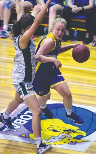  ?? FORCING THE ISSUE: Townsville’s Haylee Andrews looks for a way past an Ipswich defender during their clash at Townsville Stadium last night. Picture: SCOTT RADFORD- CHISHOLM ??