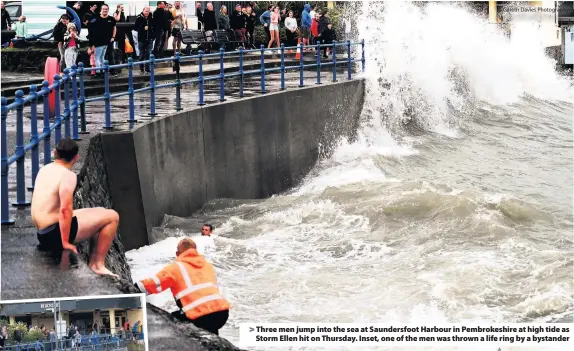  ?? Gareth Davies Photograph­y ?? >
Three men jump into the sea at Saundersfo­ot Harbour in Pembrokesh­ire at high tide as Storm Ellen hit on Thursday. Inset, one of the men was thrown a life ring by a bystander