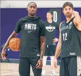  ?? Brooklyn Nets ?? IT’S A START: Caris LeVert and Joe Harris take a break during the Nets’ first practice in Orlando. The shorthande­d team will soon be getting reinforcem­ents.
