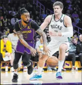  ?? Jae C. Hong The Associated Press ?? Lakers guard D’angelo Russell passes under pressure by Bucks center Brook Lopez during Los Angeles’ win Friday.