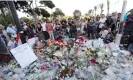  ?? Photograph: Valéry Hache/AFP/Getty ?? People gather around a makeshift memorial in July 20216 to pay tribute to the victims of the attack on the Nice seafront.