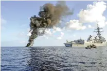  ?? AFP ?? The USS Farragut passes by the smoke from a suspected pirate skiff it disabled in 2010 in the Gulf of Aden