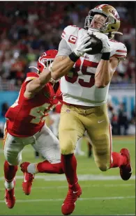  ?? (AP/Mark Humphrey) ?? George Kittle of the San Francisco 49eres catches a pass in front of Daniel Sorensen of the Kansas City Chiefs at the end of the first half that was called back because of an offensive pass interferen­ce penalty on Kittle. The penalty added scrutiny during a season in which pass interferen­ce penalties were subject to instant replay review, and coaches and players complained about a lack of consistenc­y when it was called.