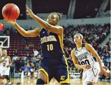  ?? THE ASSOCIATED PRESS ?? UTC guard Queen Alford (10) reaches for a rebound as Mississipp­i State guard Dominique Dillingham (00) comes in to defend during the first half of the host Lady Bulldogs’ 60-50 win in the NCAA tournament.