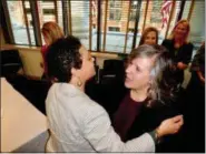  ?? MICHAEL P. RELLAHAN - DIGITAL FIRST MEDIA ?? Jennifer Lopez, nationally recognized for her work in the criminal justice system, greets a colleague on her last day of work at the Chester County Adult Probation Office, as county commission­ers Chairwoman Michelle Kichline and Common Pleas Judge Ann Marie Wheatcraft look on.