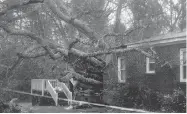  ?? CHUCK BURTON / THE ASSOCIATED PRESS ?? A fallen tree is shown after it crashed through the home where a woman and her baby were killed in Wilmington, N.C., after hurricane Florence made landfall Friday.