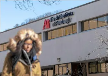  ?? Steph Chambers/Post-Gazette ?? A pedestrian passes the Art Institute of Pittsburgh on Jan. 31 in the Strip District.