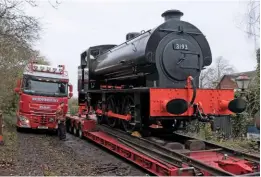  ?? ANDREW MURRAY ?? Hunslet ‘Austerity’ 0-6-0ST Works No. 3193 ‘Norfolk Regiment’ is loaded onto a trailer at Yaxham for its journey to Bressingha­m on November 28.